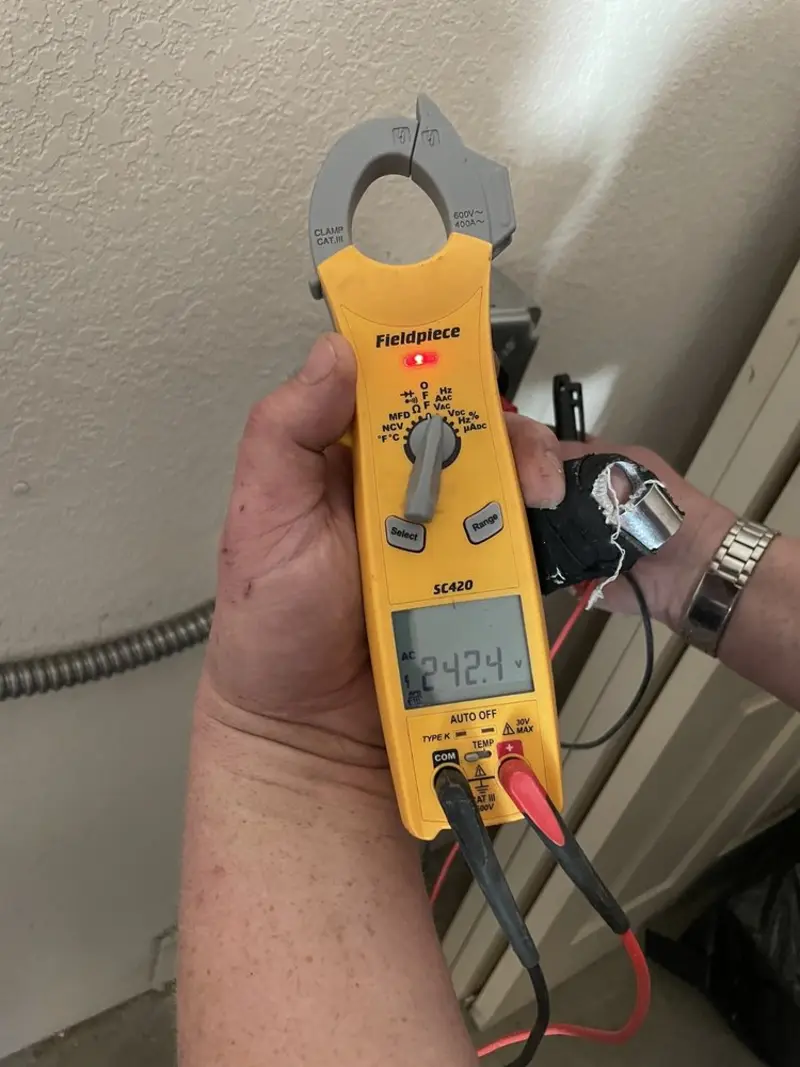 Voltage testing with clamp meter during Outlet Installation in Terrell Hills